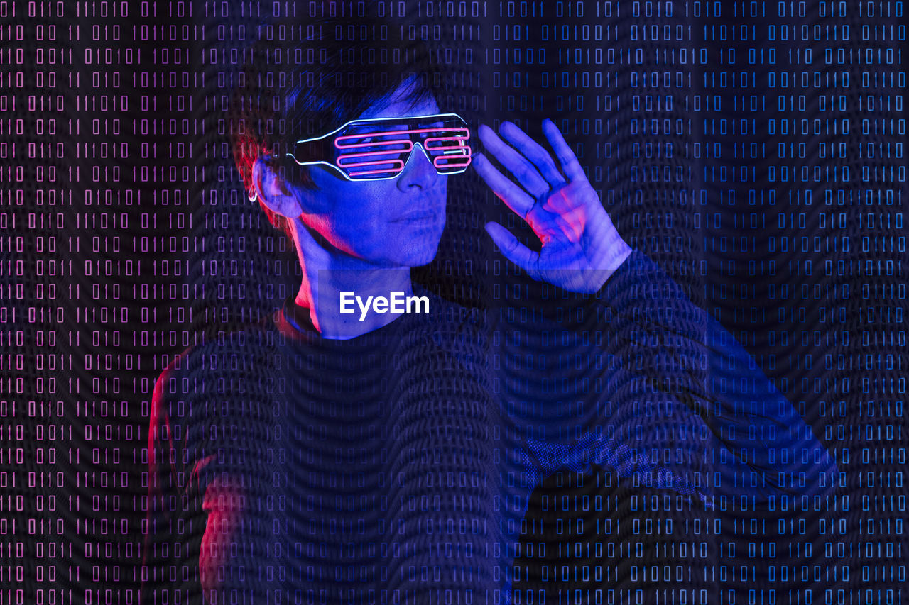 Mature woman wearing futuristic glasses with binary code