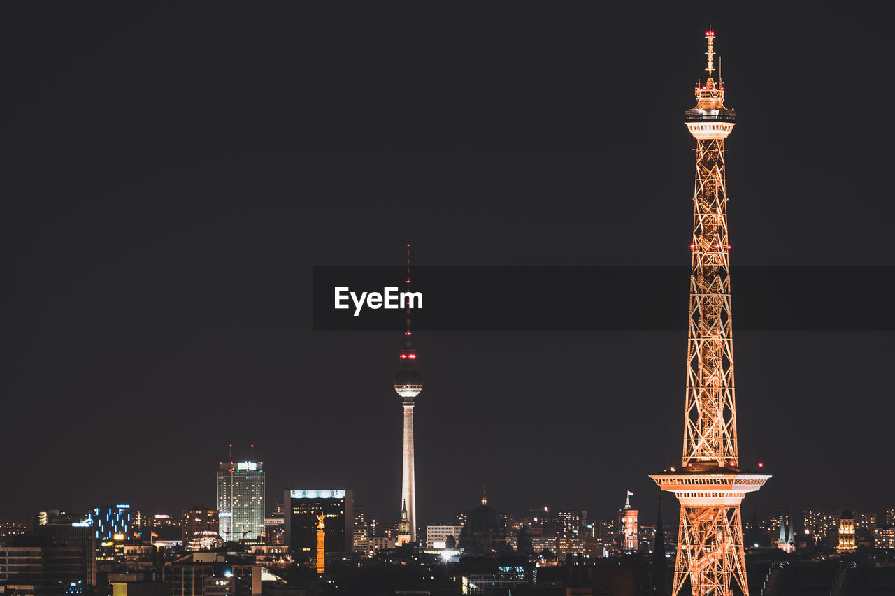 Cityscape against clear sky at night