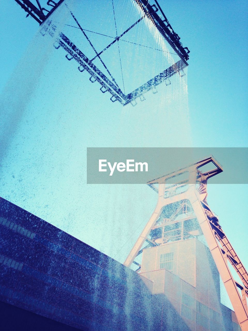 Low angle view of shaft tower at zollverein coal mine industrial complex against sky