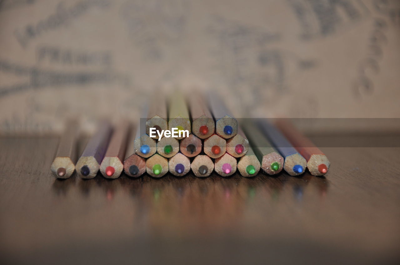 multi colored, indoors, large group of objects, pencil, no people, art, writing instrument, table, creativity, still life, variation, selective focus, close-up, wood, colored pencil, in a row