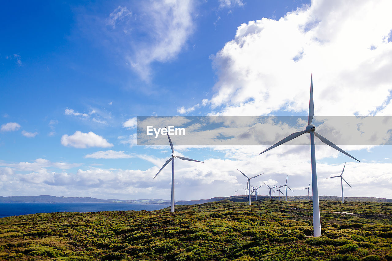 WINDMILL ON FIELD AGAINST SKY