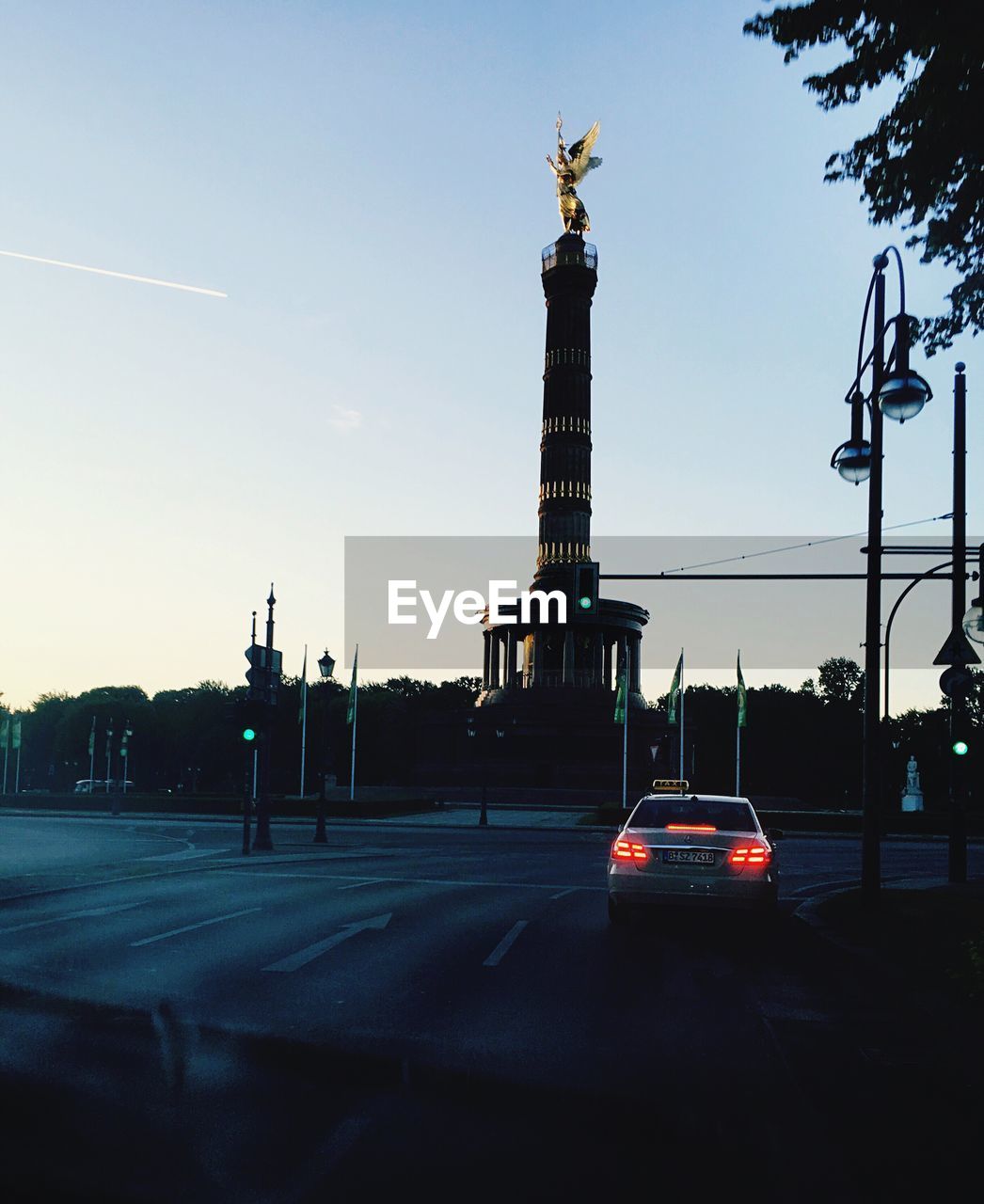 Car on road against sky during sunset