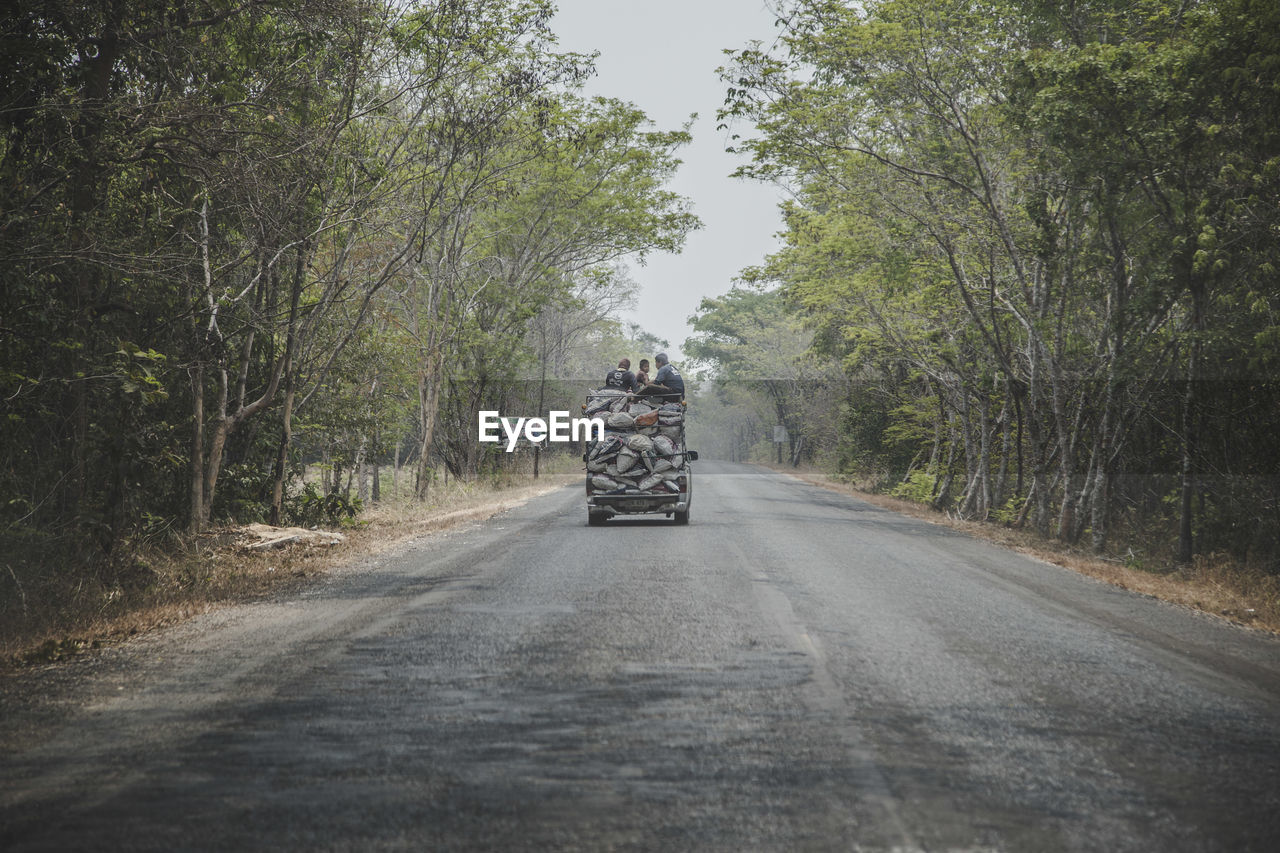 People traveling in vehicle on road