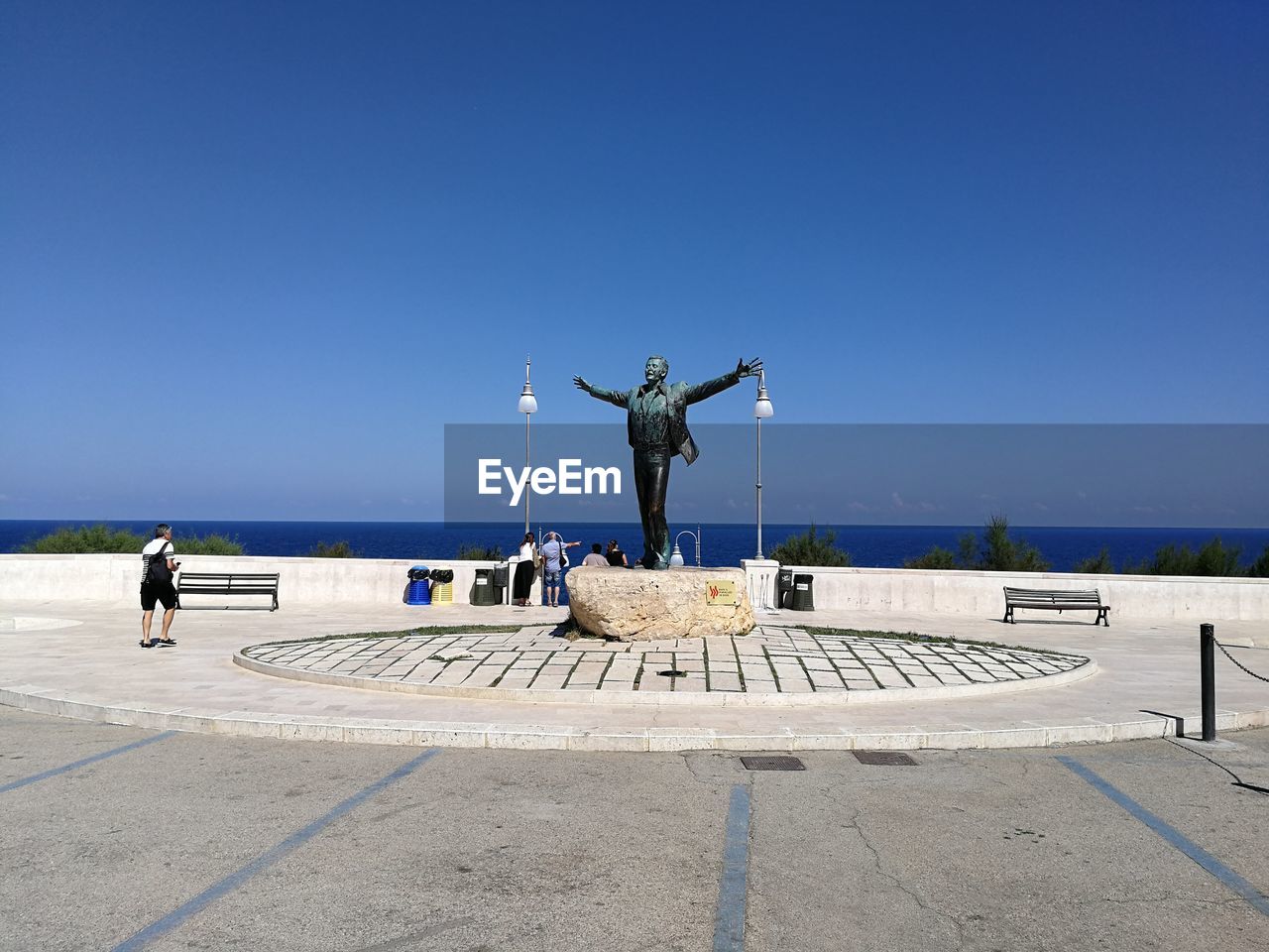 STATUE BY SEA AGAINST CLEAR SKY