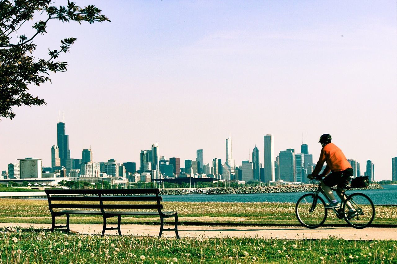 View of man riding bicycle in city