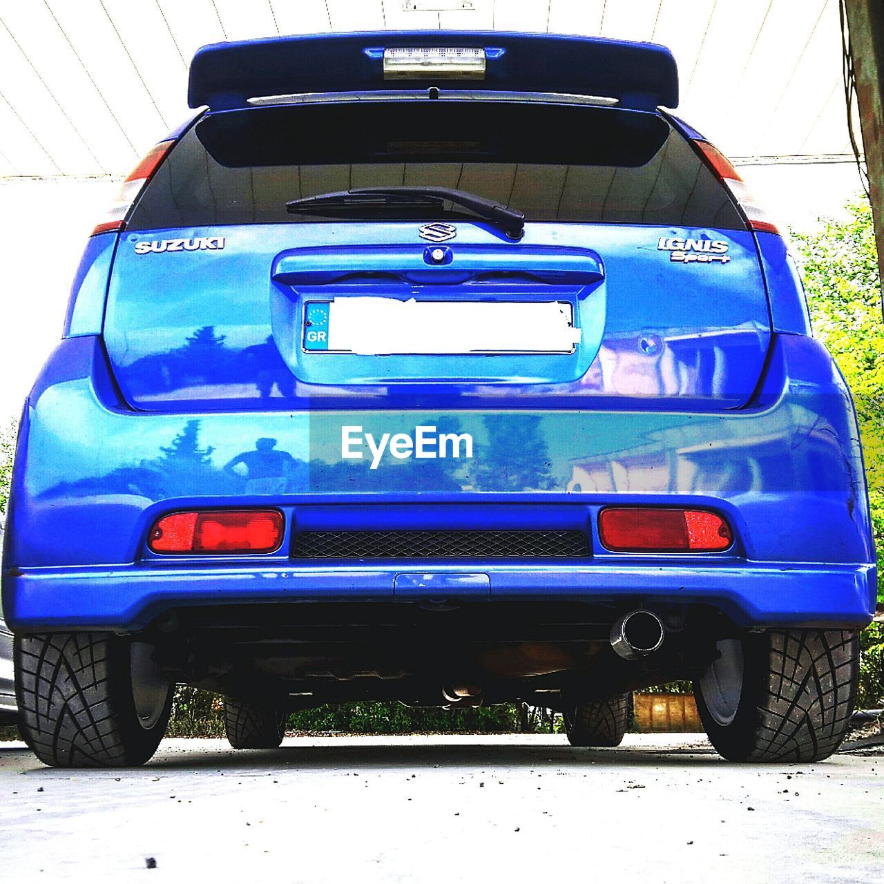 CAR IN BLUE CONTAINER