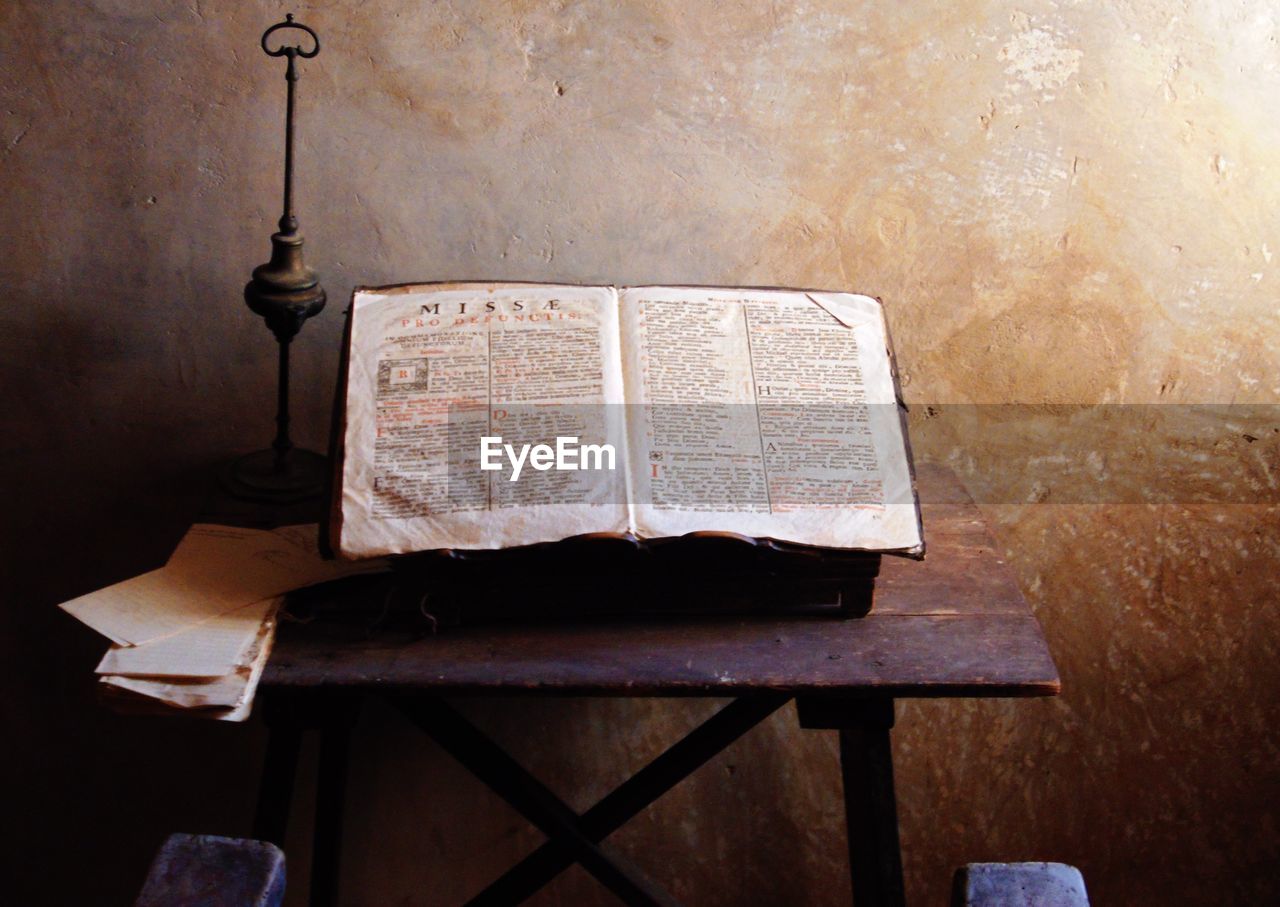 Bible on table against wall