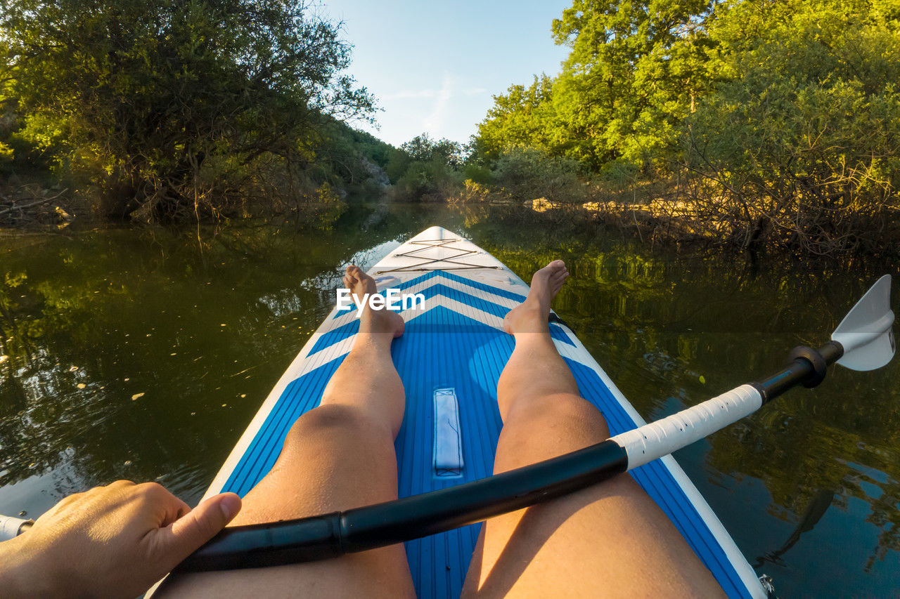 low section of woman sitting in boat