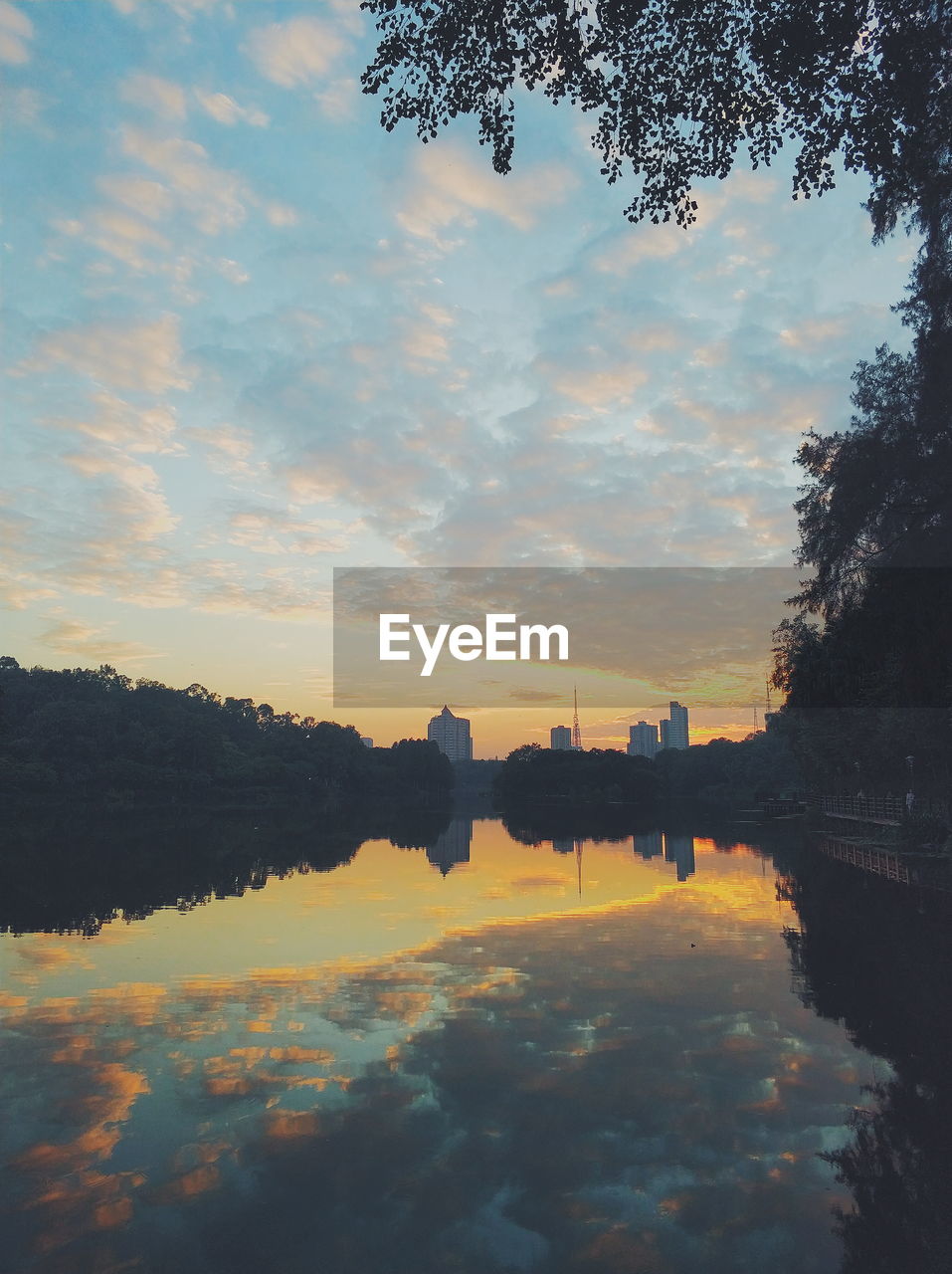 Scenic view of river against sky at sunset