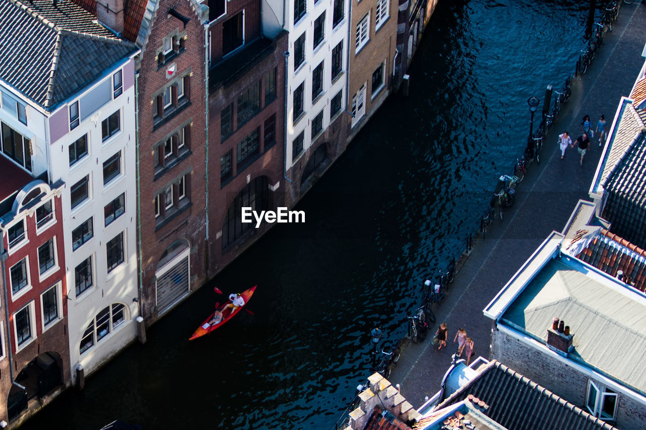 High angle view of boats in canal along buildings