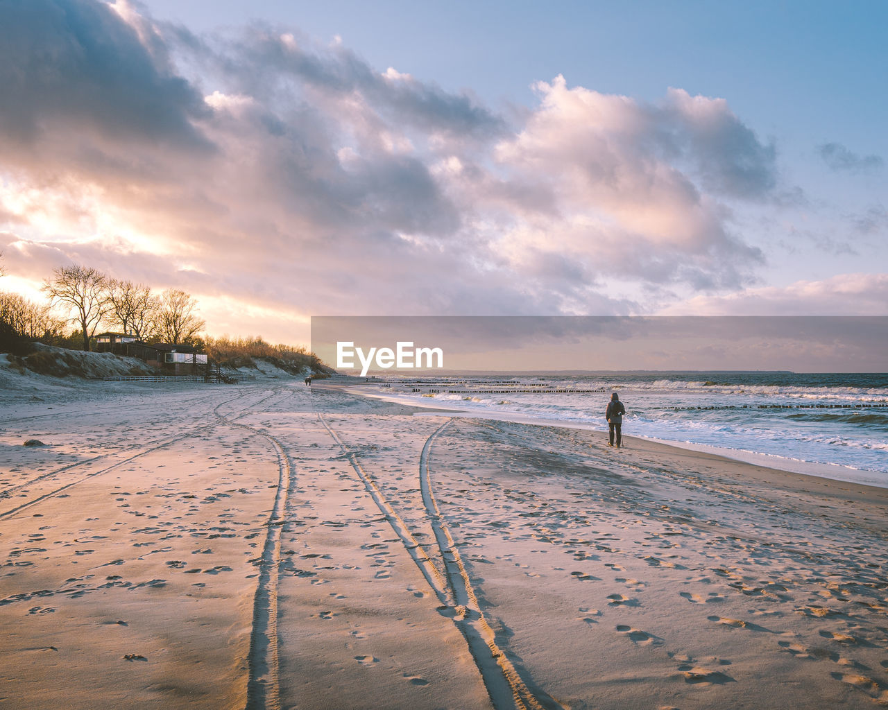 Scenic view of beach against sky during sunset