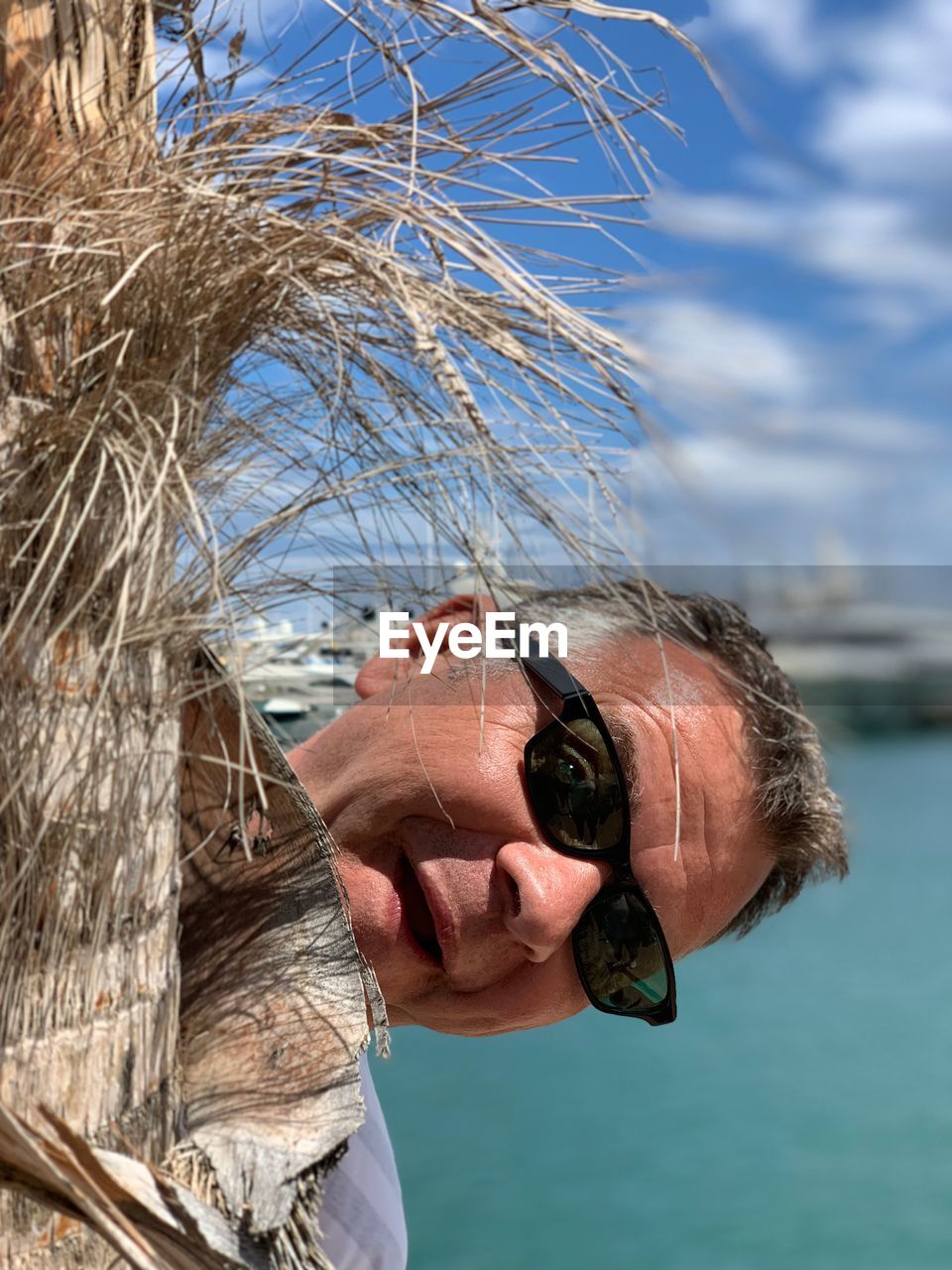 Portrait of man wearing sunglasses at beach