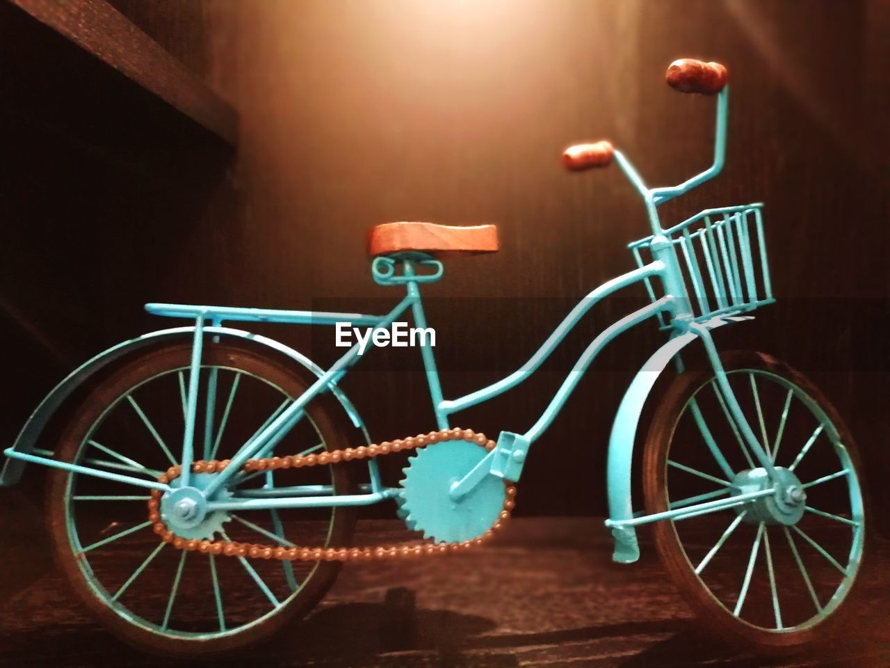 BICYCLE PARKED AGAINST WALL IN ILLUMINATED ROOM