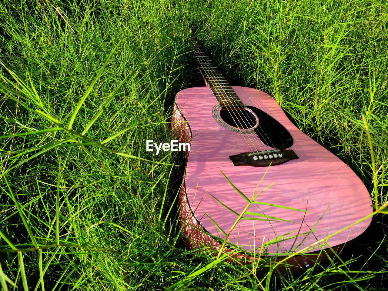 High angle view of guitar on field