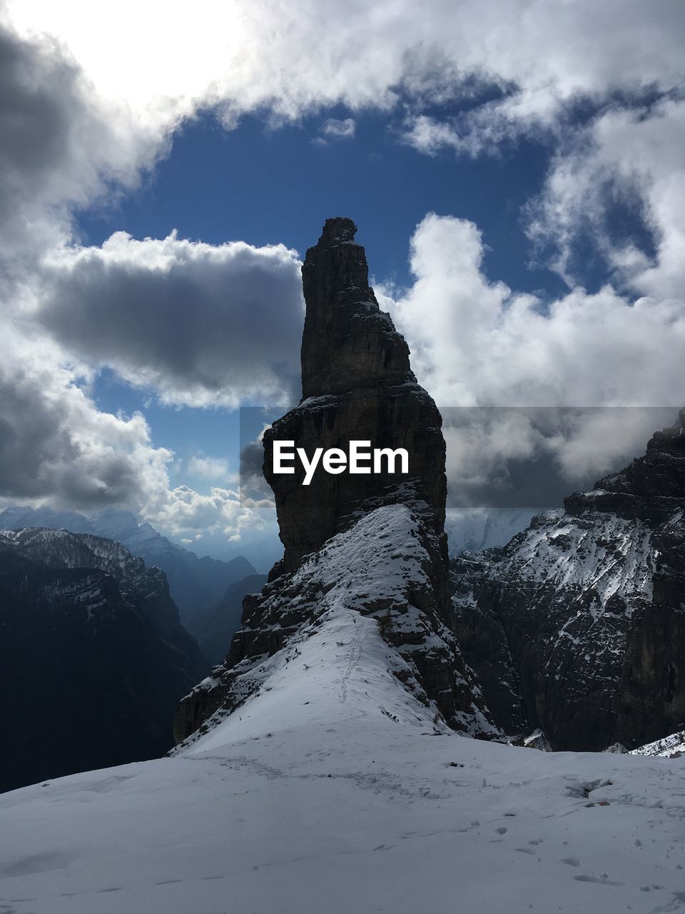 Low angle view of snow covered mountain against sky