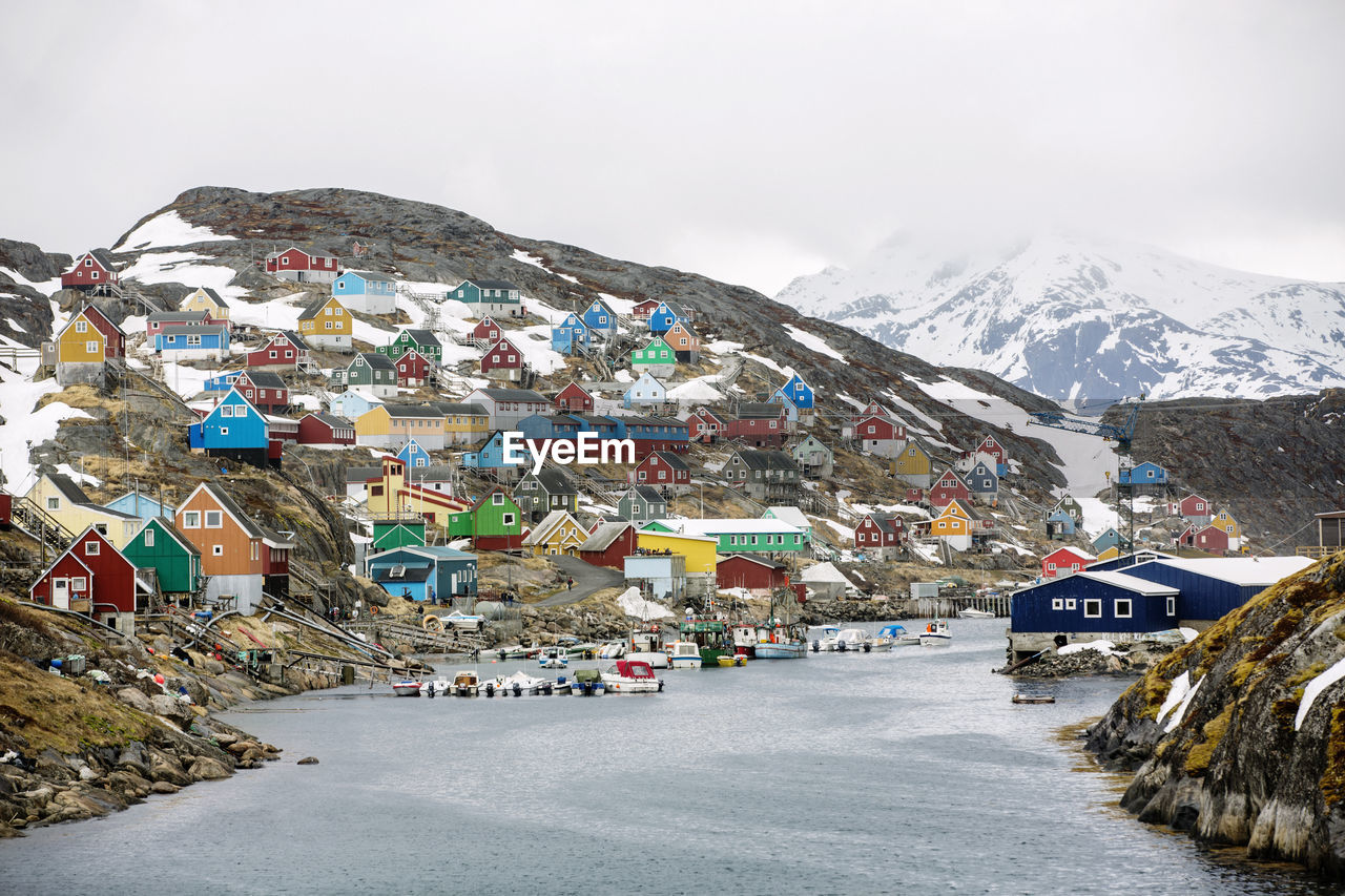 Village by river in winter