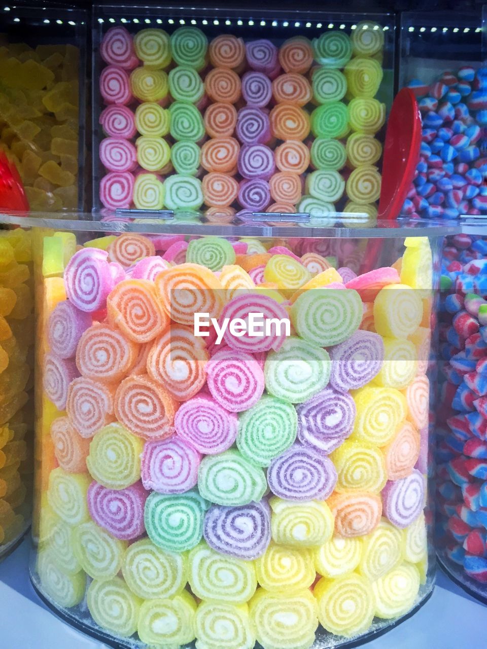 Close-up of colorful candies in jars for sale at store
