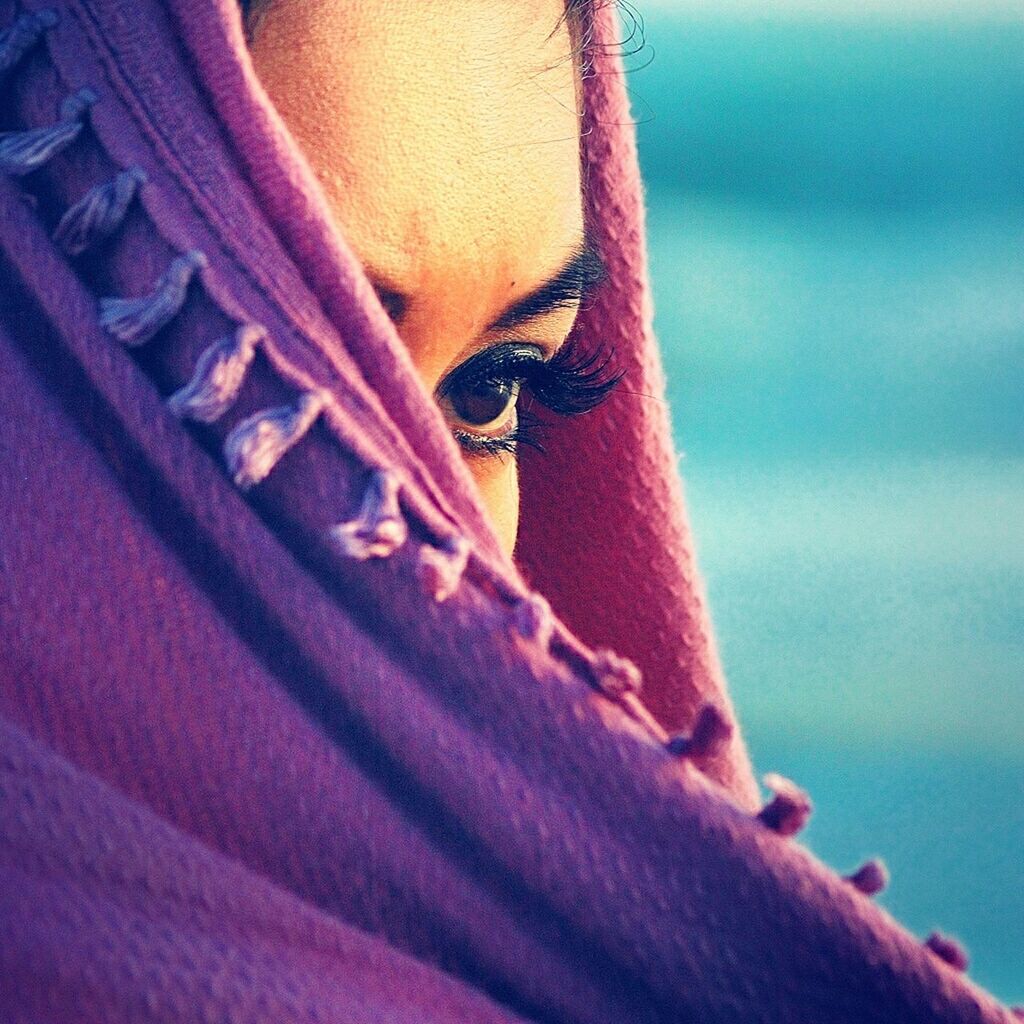 Woman covering her face with shawl