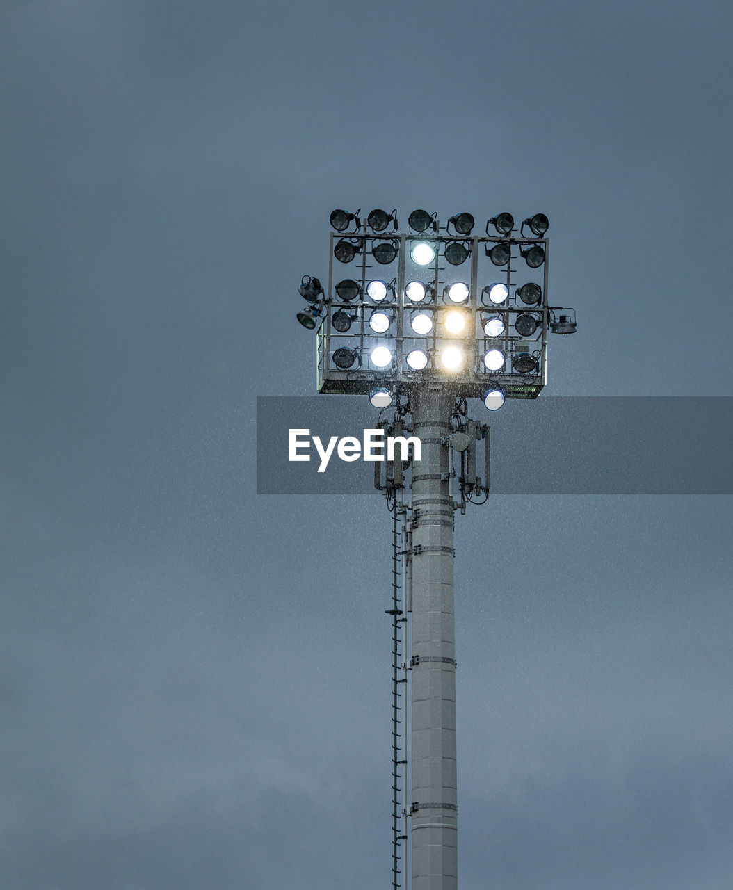 LOW ANGLE VIEW OF ILLUMINATED LIGHTS AGAINST SKY