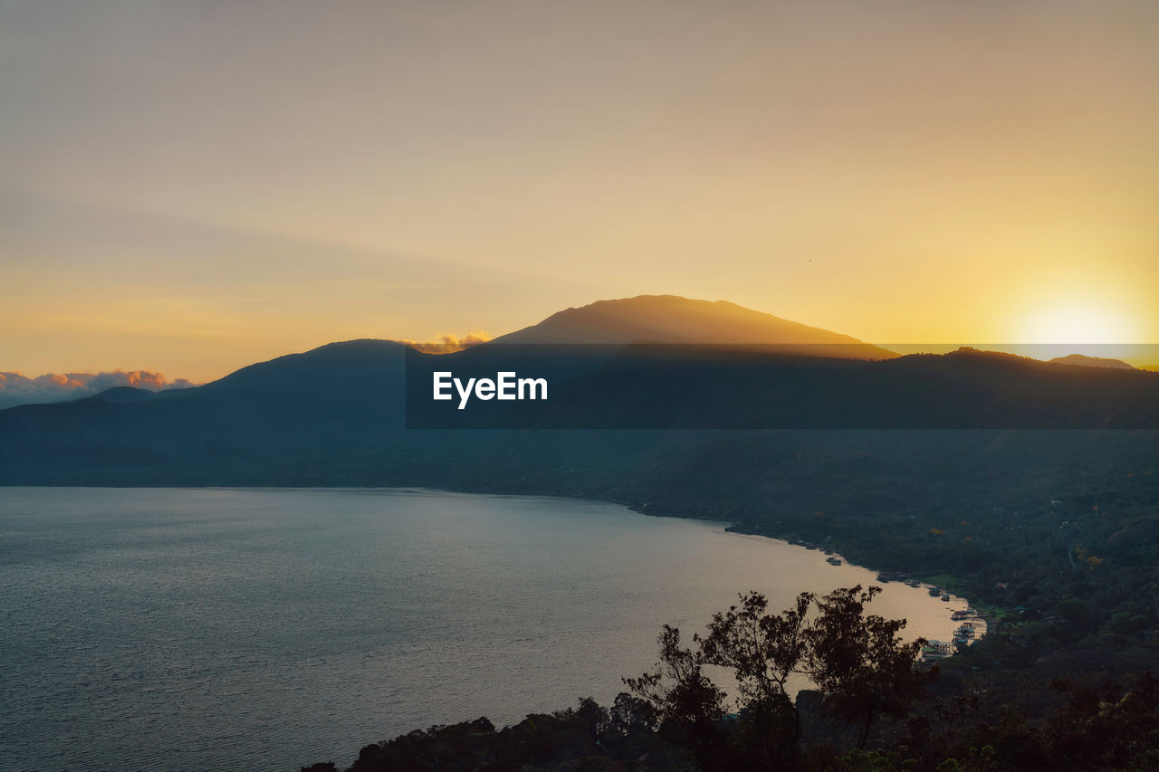 Scenic view of silhouette mountains against sky during sunset