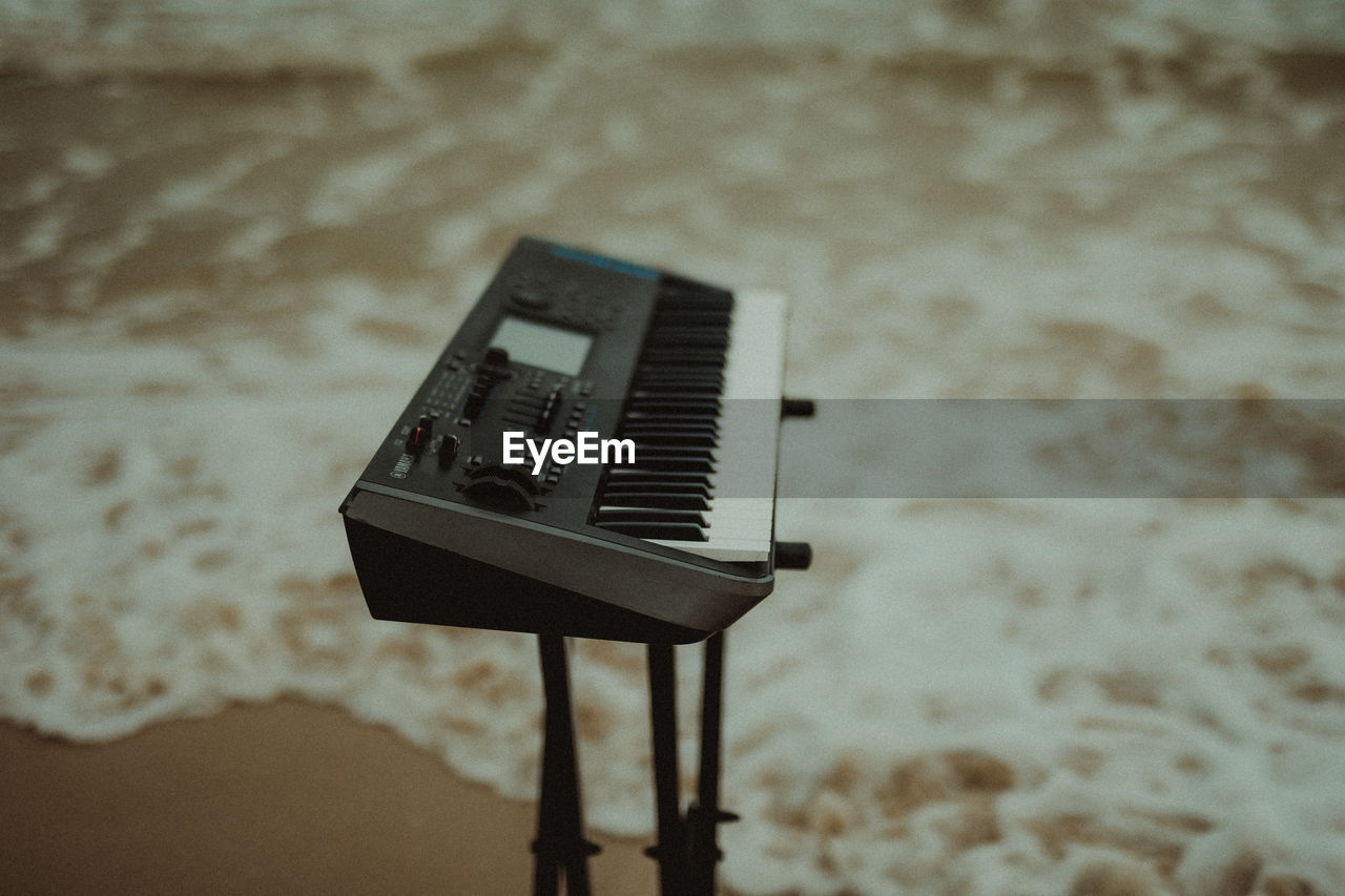 Close-up of piano on beach