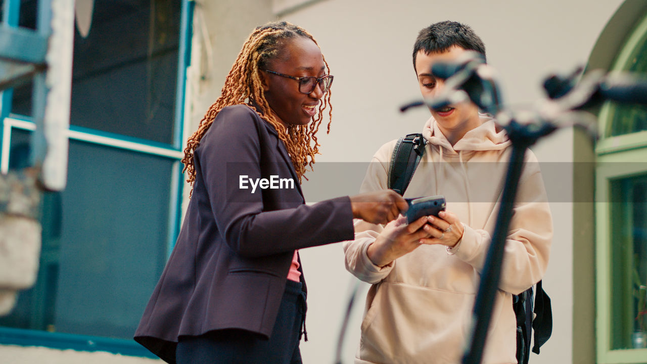 side view of young man using mobile phone
