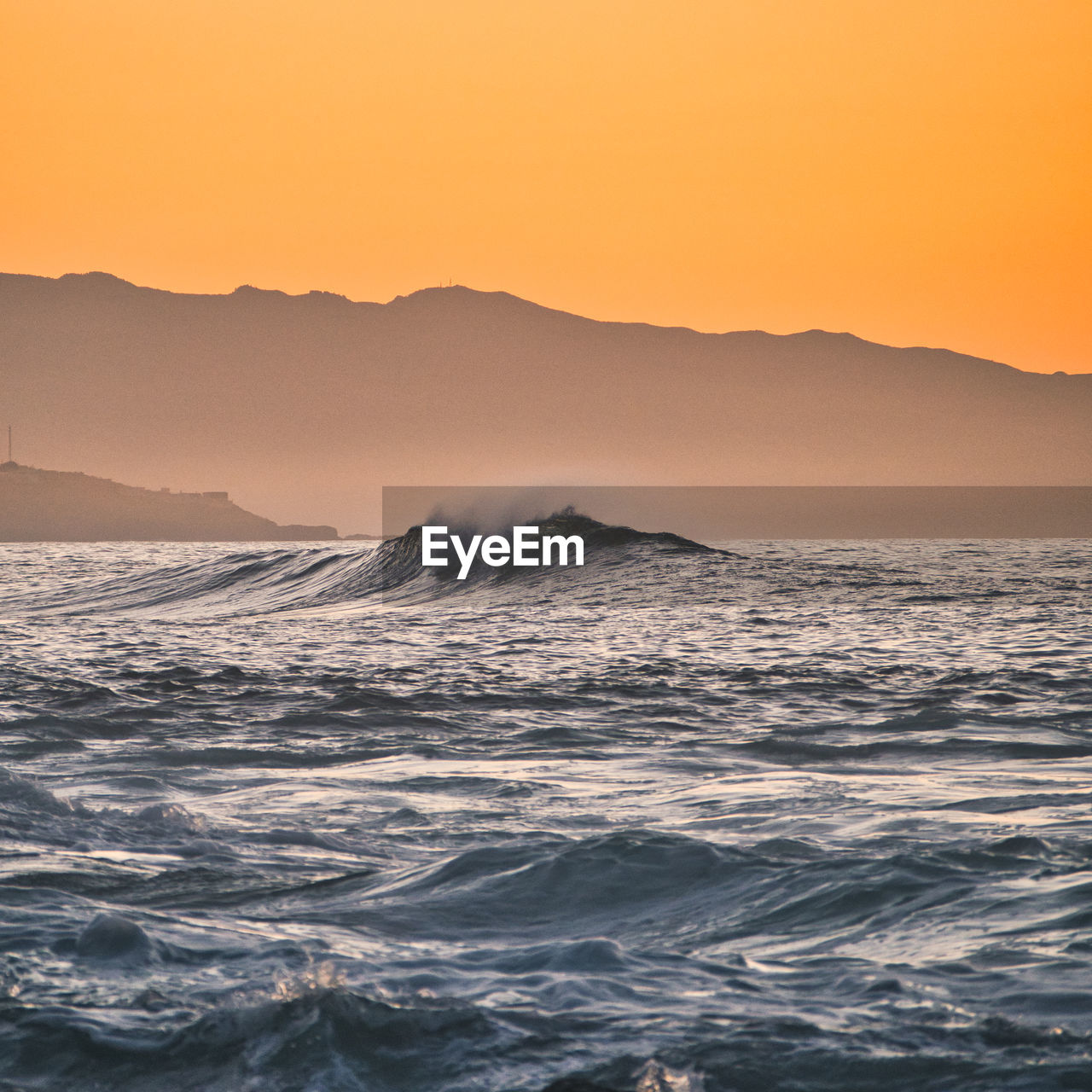 Scenic view of sea against clear sky during sunset