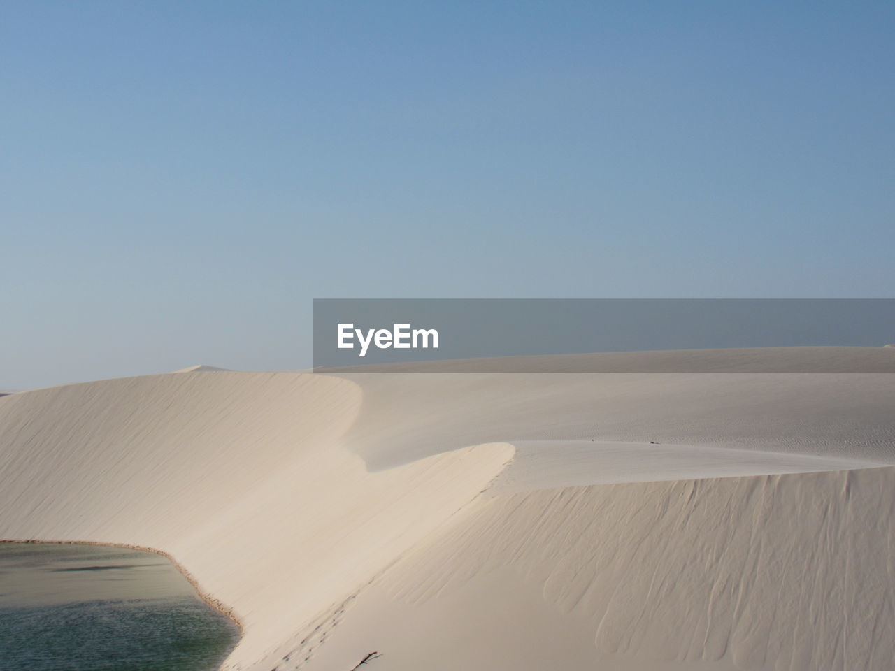 Scenic view of desert against clear blue sky