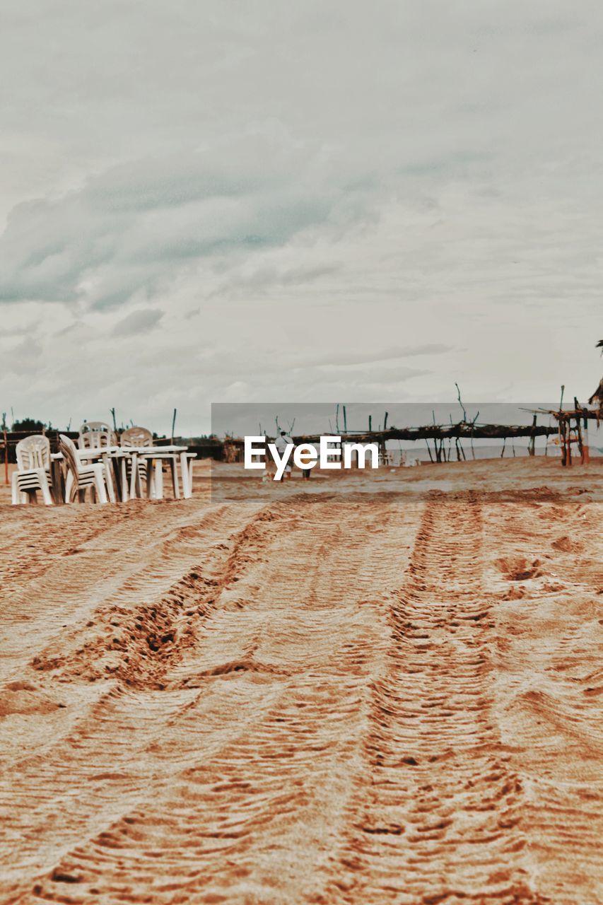 WOODEN POSTS ON BEACH
