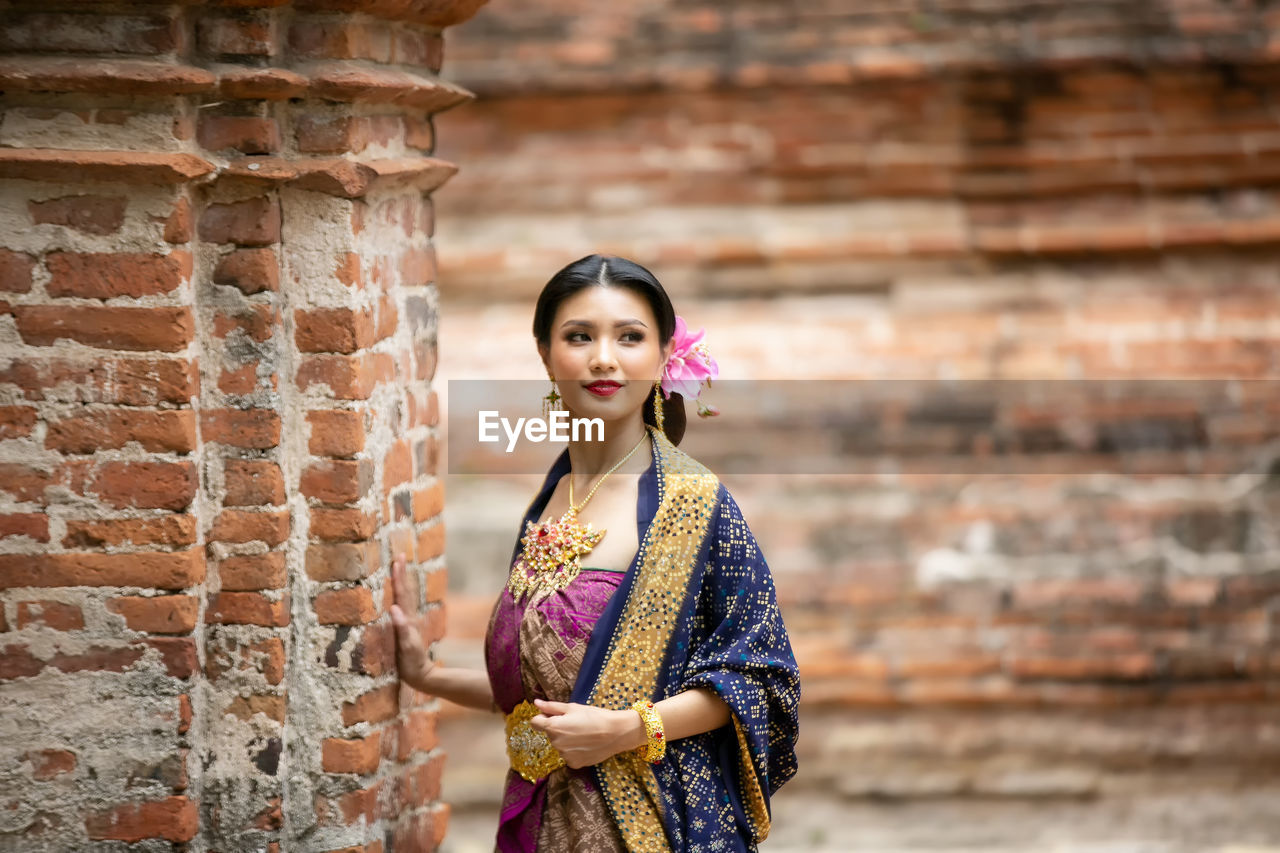 Woman in traditional clothing standing outdoors