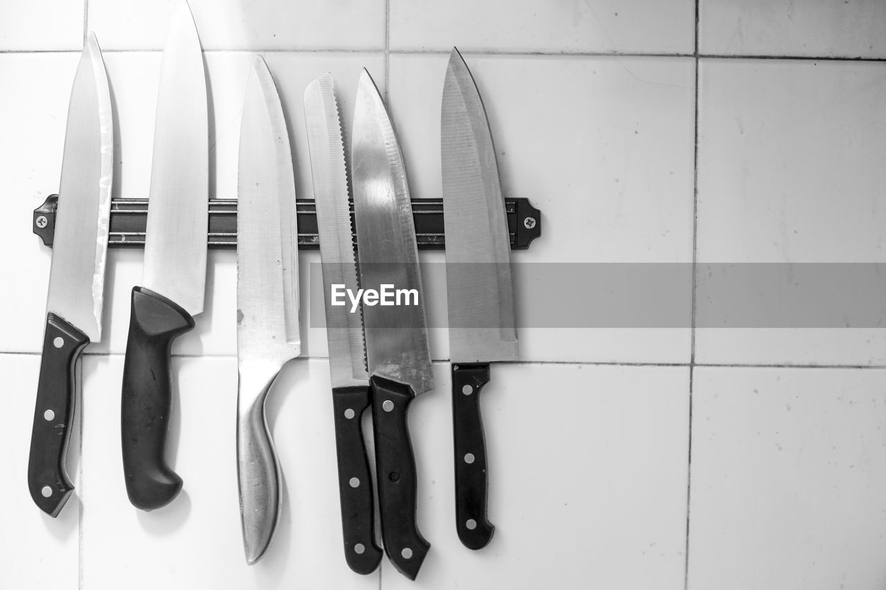 High angle view of knives on tiled floor
