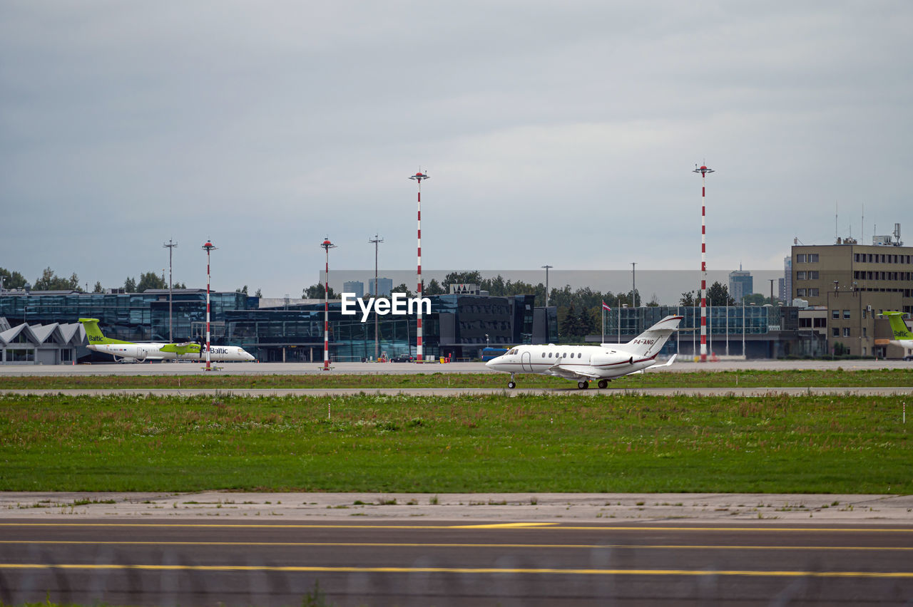 AIRPLANE ON RUNWAY AGAINST SKY