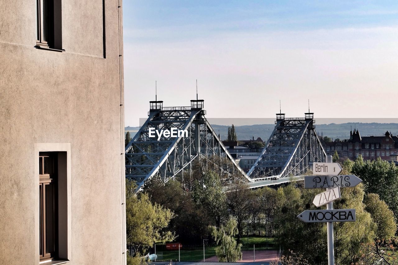 Direction sign with bridge in background