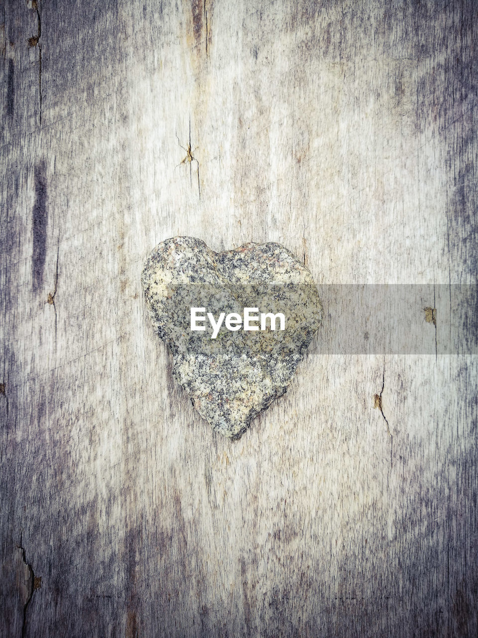 CLOSE-UP OF HEART SHAPE WOOD ON WOODEN FLOOR