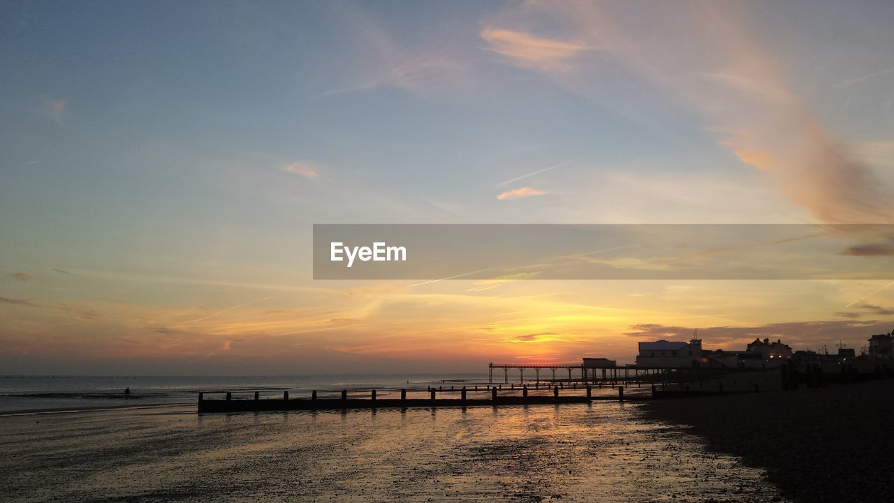 Scenic view of sea against sky at sunset