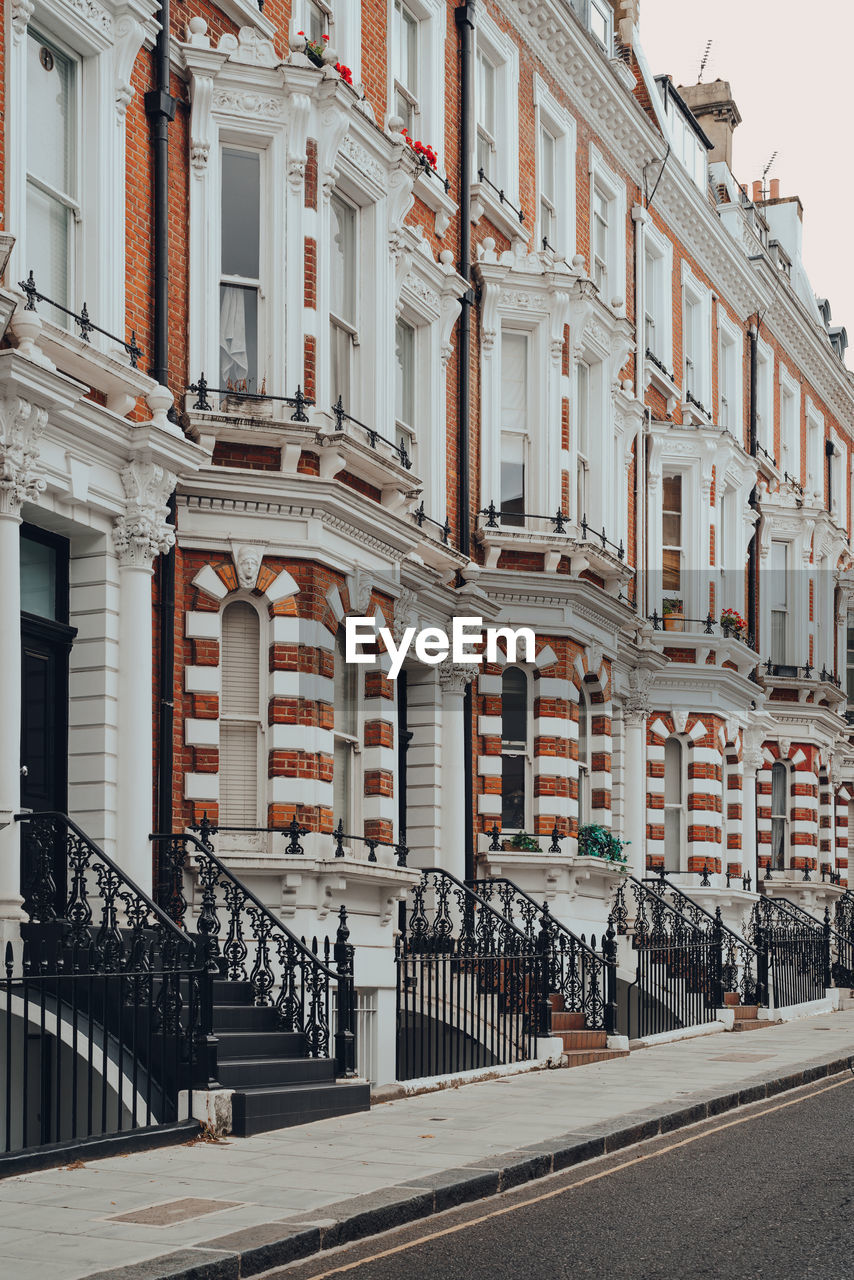 Row of traditional victorian houses with stoops in kensington and chelsea, london, uk.