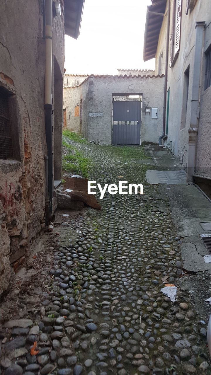 COBBLESTONE STREET AMIDST BUILDINGS