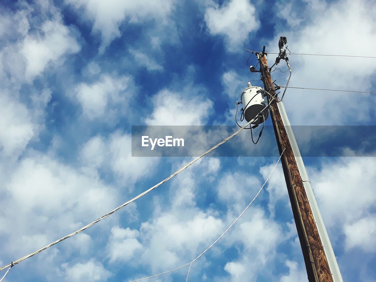 Low angle view of electricity pylon against sky