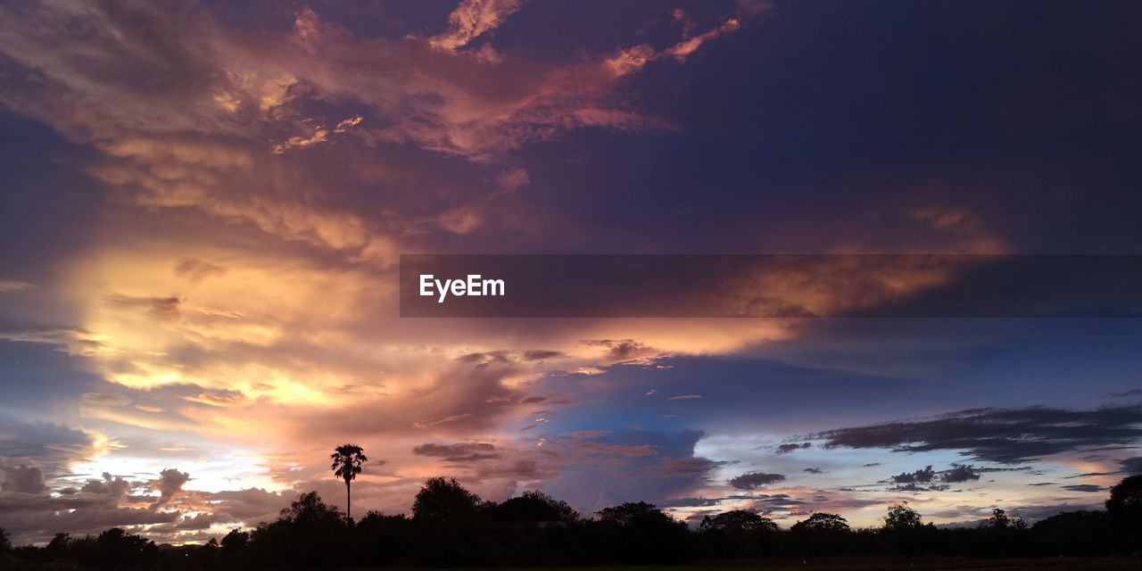 sky, cloud, sunset, environment, beauty in nature, afterglow, nature, landscape, scenics - nature, dusk, dramatic sky, evening, horizon, tree, plant, cloudscape, silhouette, tranquility, no people, sunlight, land, tranquil scene, red sky at morning, orange color, outdoors, sun, multi colored, idyllic, blue, twilight, rural scene