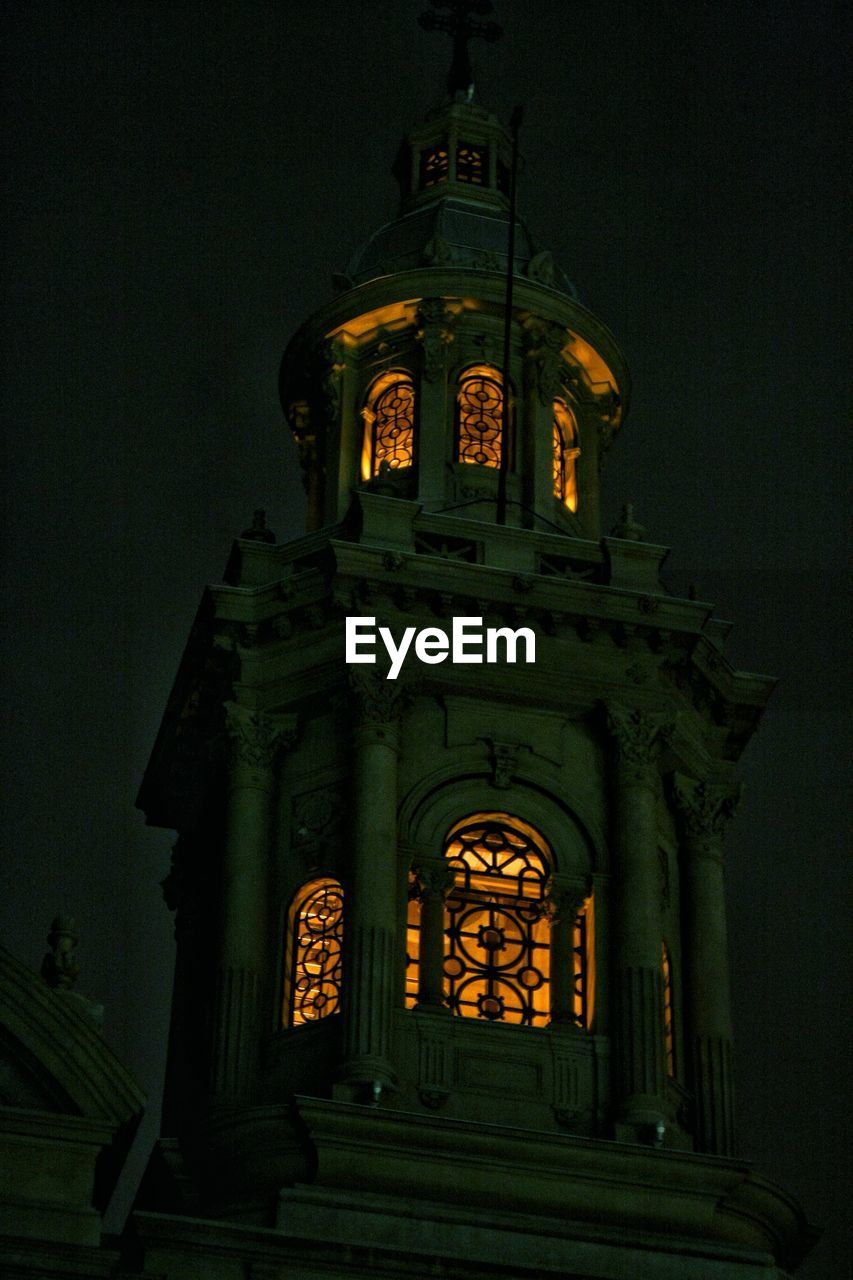 LOW ANGLE VIEW OF ILLUMINATED CATHEDRAL AGAINST SKY AT NIGHT