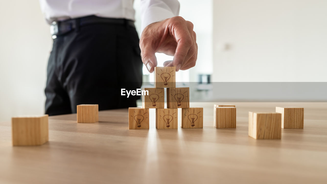 MAN PLAYING WITH TOY ON TABLE AT HOME