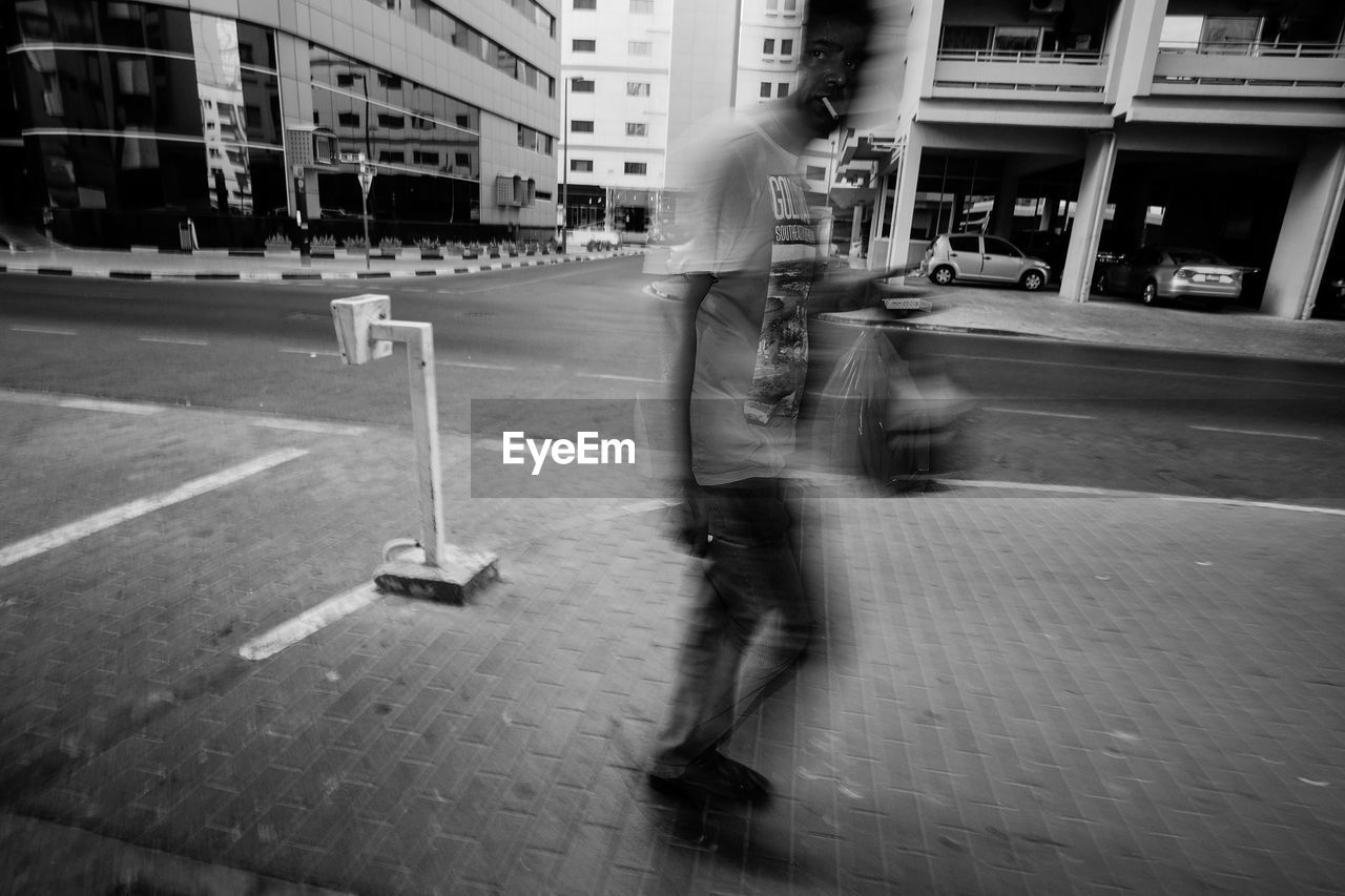 WOMAN STANDING IN CITY