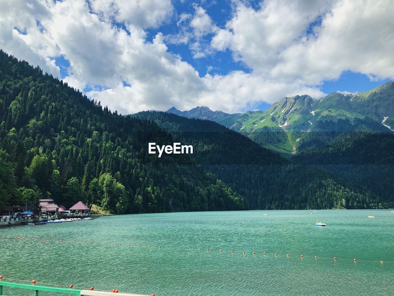 Scenic view of lake by mountains against sky