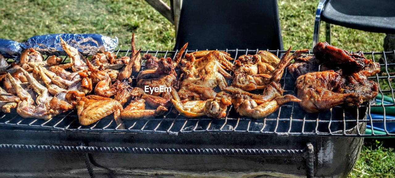 High angle view of chicken wings on barbeque