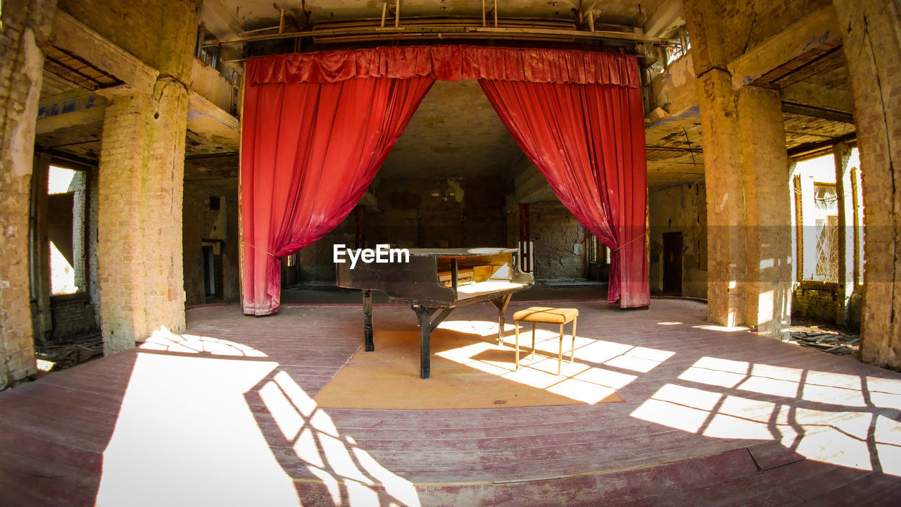 EMPTY CHAIRS AND TABLE IN BUILDING