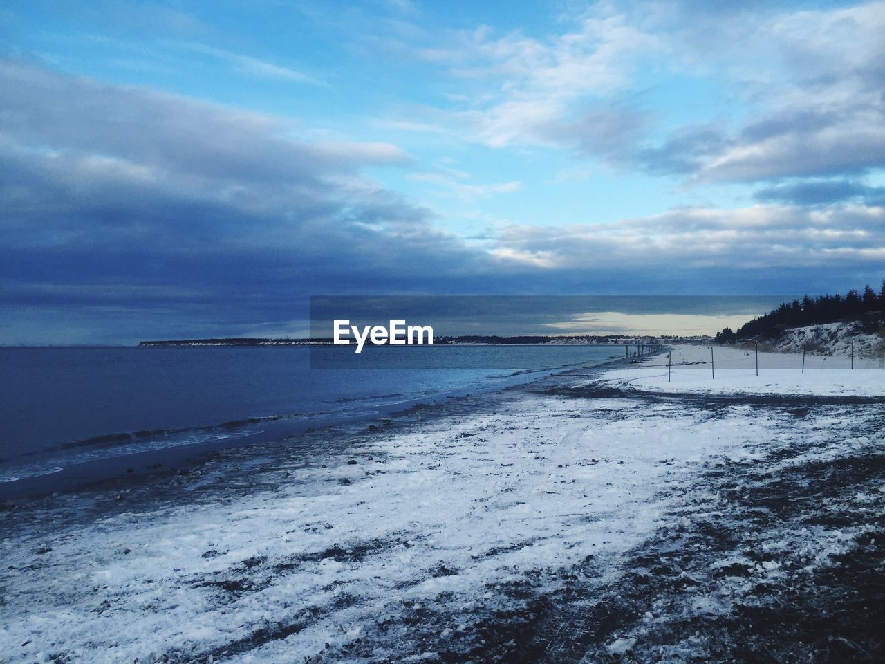 Scenic view of sea against cloudy sky