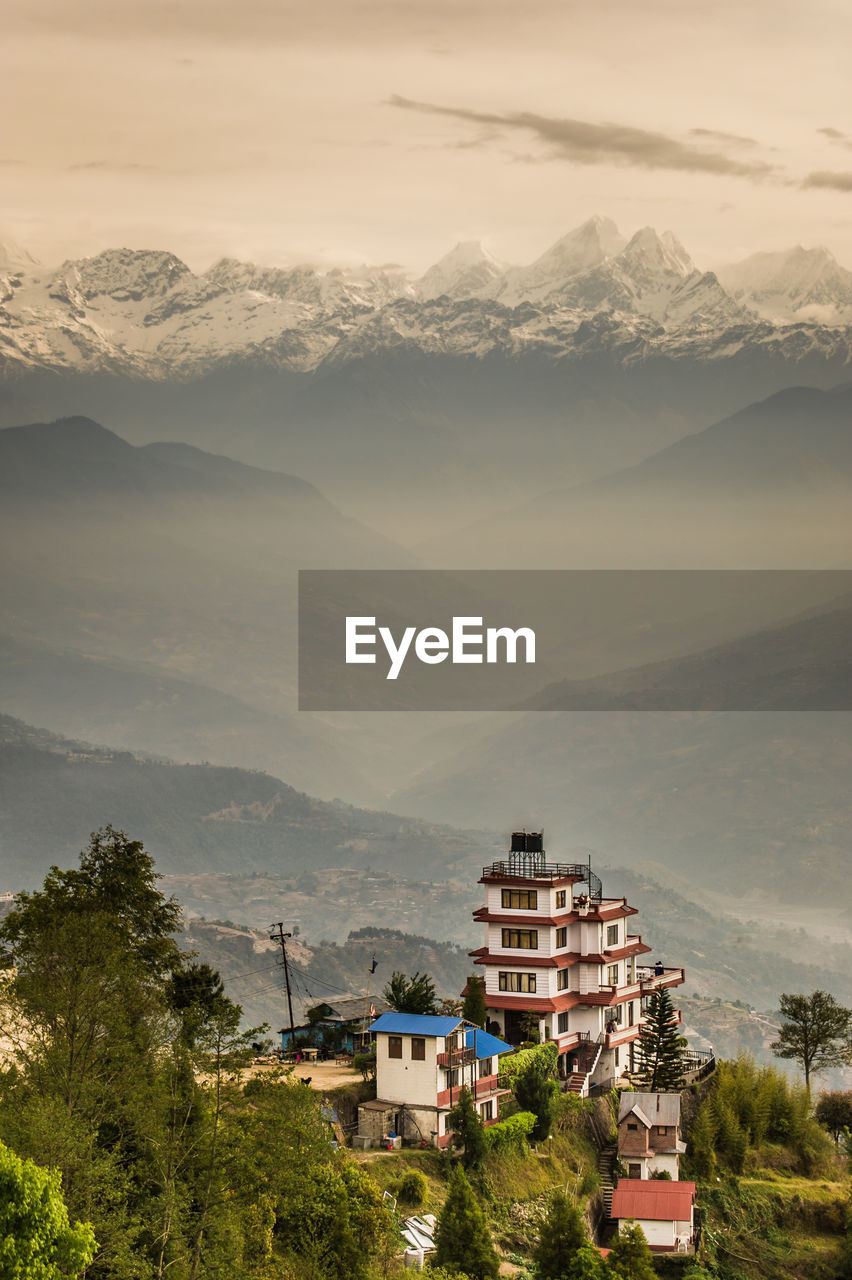 Town by mountains against sky