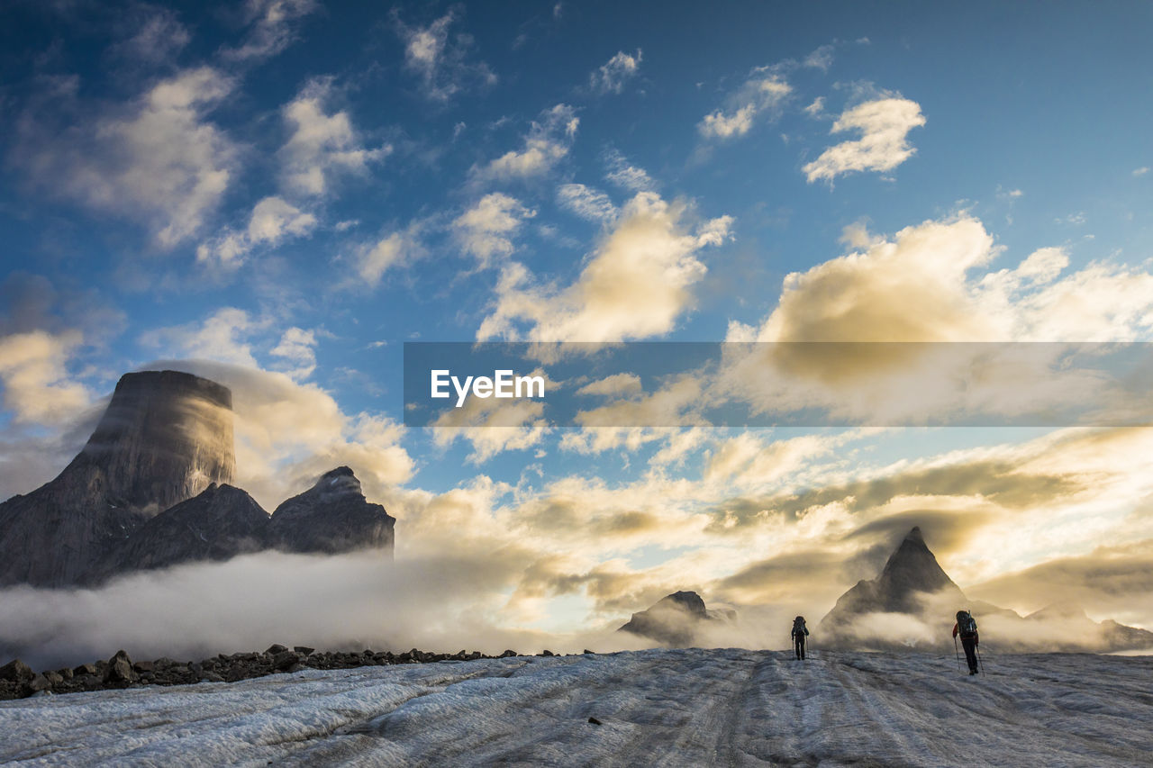 Climbers set up tent on glacier below mt. loki, baffin island.