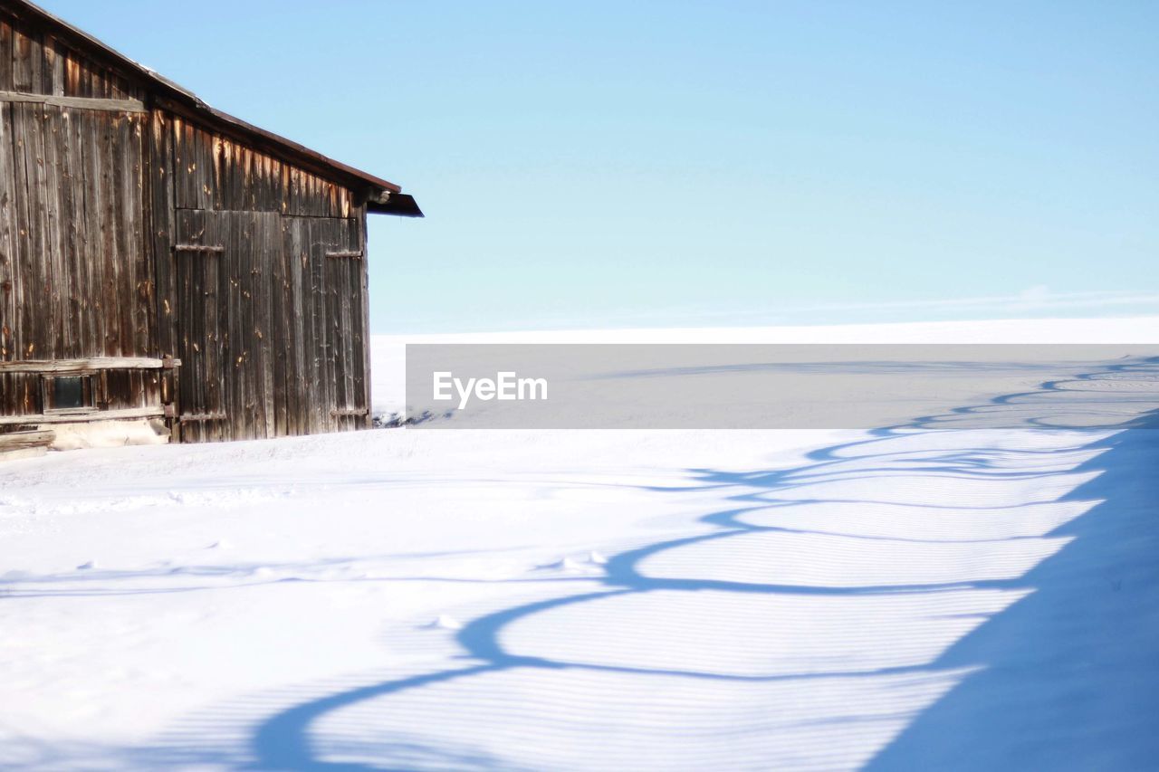 Scenic view of snow covered land against sky