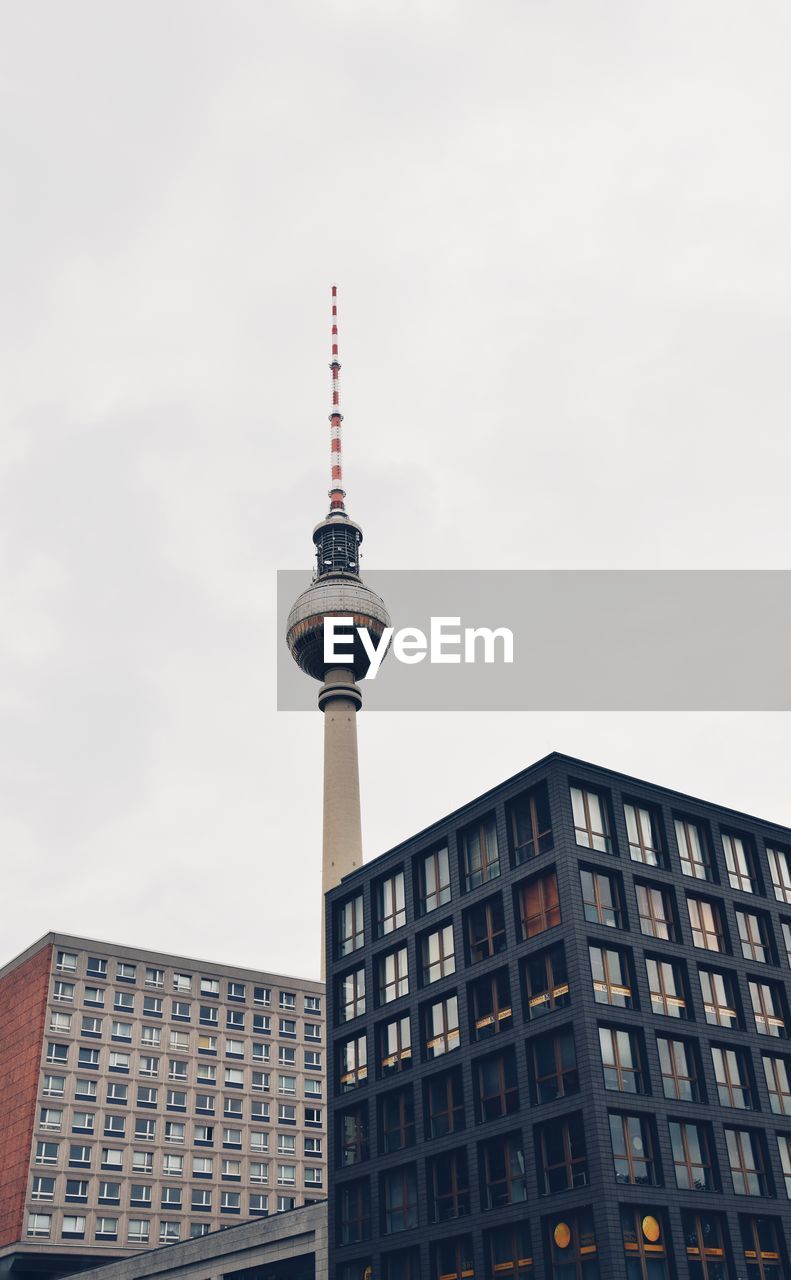 Low angle view of buildings and fernsehturm against sky